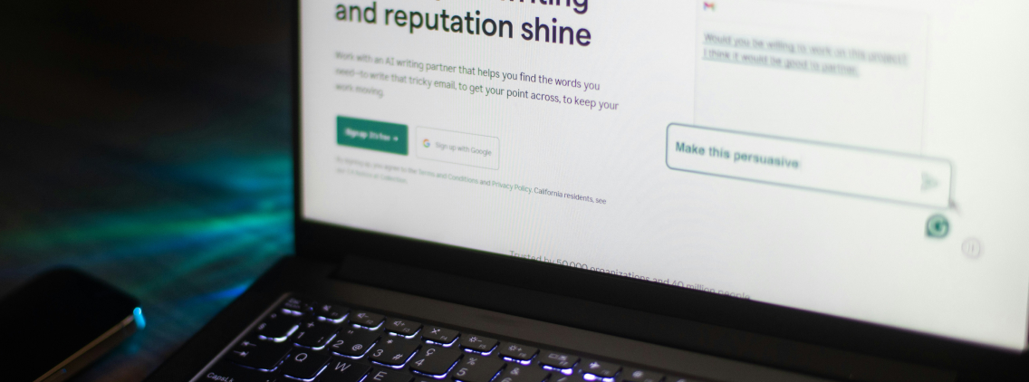 Close-up of a laptop screen displaying an AI writing assistant website interface, highlighting tools to enhance communication and writing clarity.